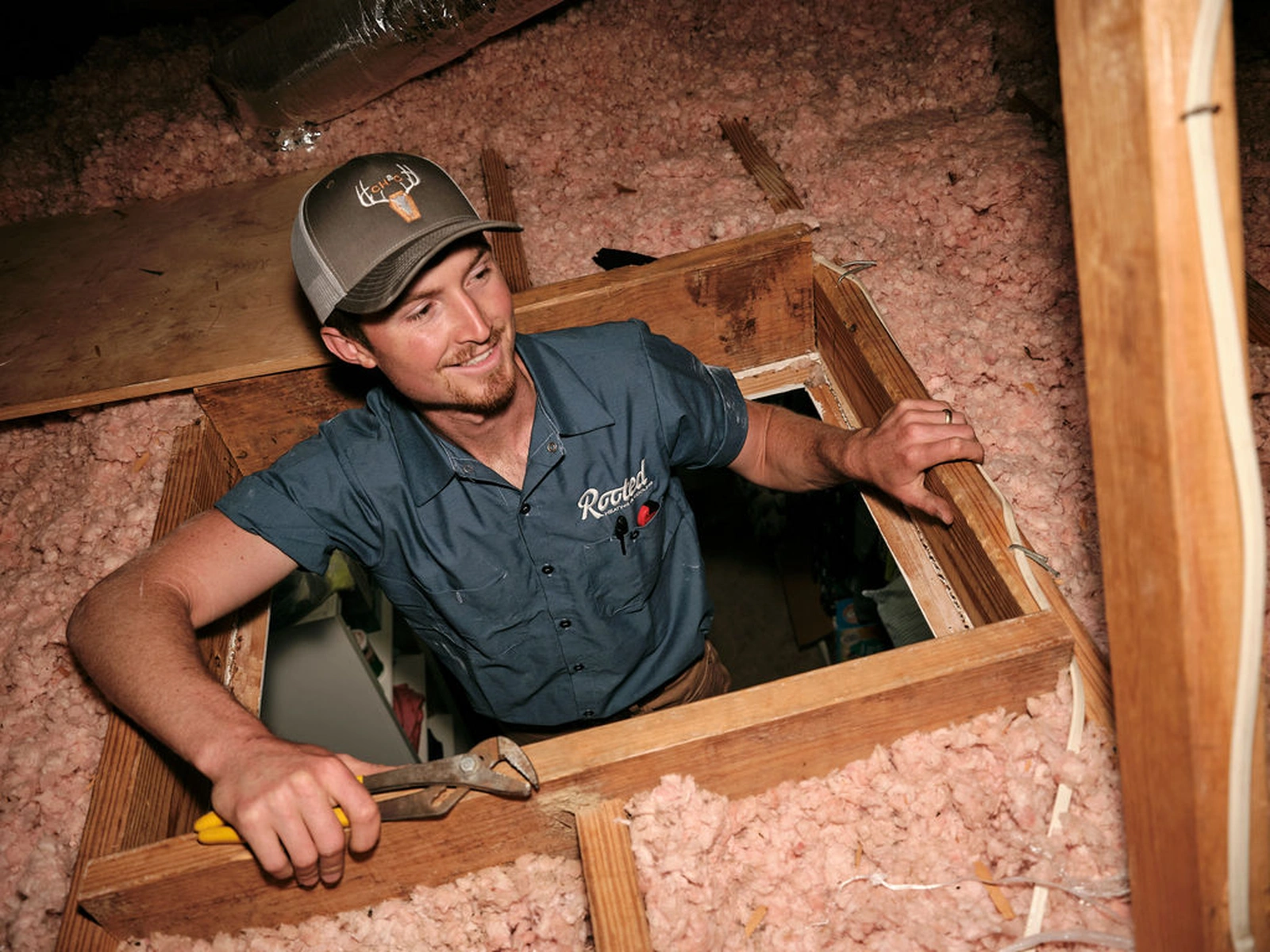 Attic insulation heating repair service technician working